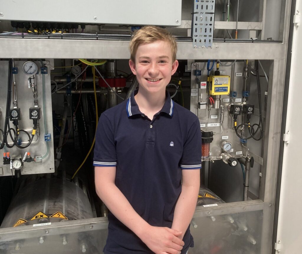 Johannes Timmerhaus, Schüler des Max-Planck-Gymnasiums in Gelsenkirchen vor dem alkalischen Elektrolyseur im Anwenderzentrum H2Herten