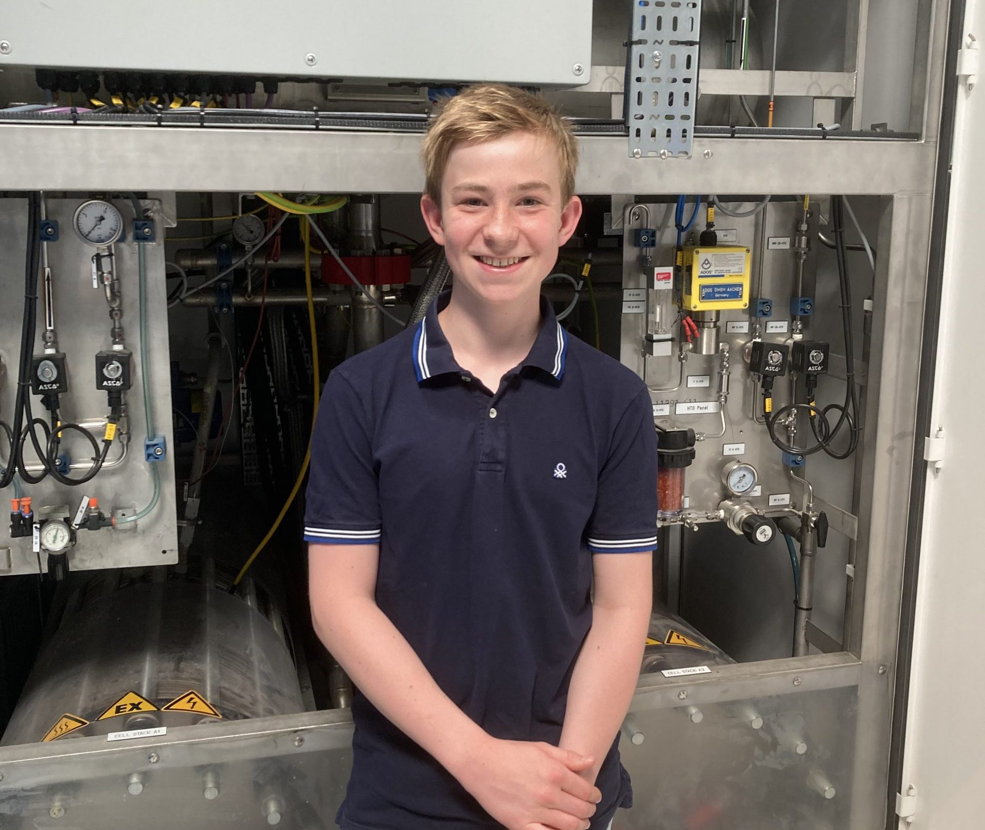 Johannes Timmerhaus, Schüler des Max-Planck-Gymnasiums in Gelsenkirchen vor dem alkalischen Elektrolyseur im Anwenderzentrum H2Herten